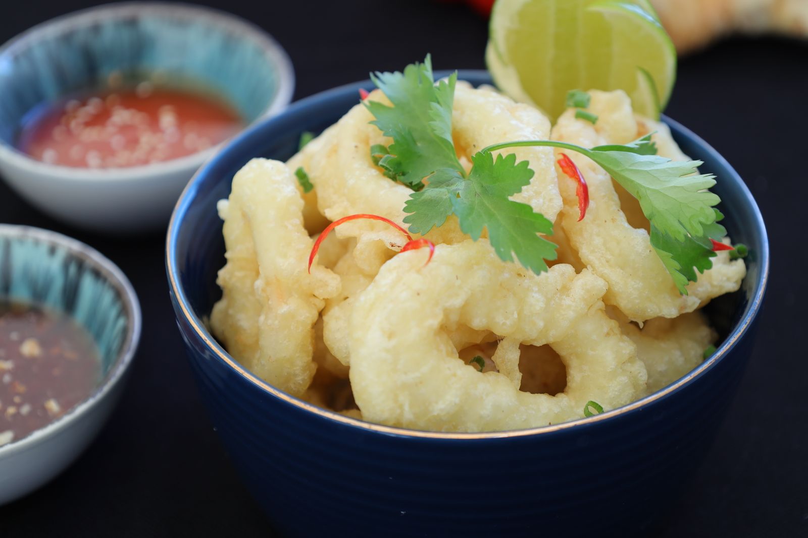 Bowl of crispy fried calamari with dipping sauces